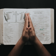 person-placing-hands-on-bible-2258251